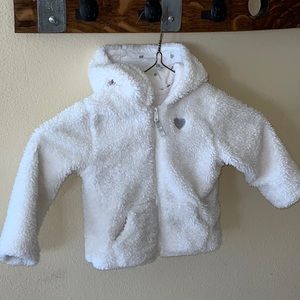 Cozy white fleece coat with embroidered silver heart.